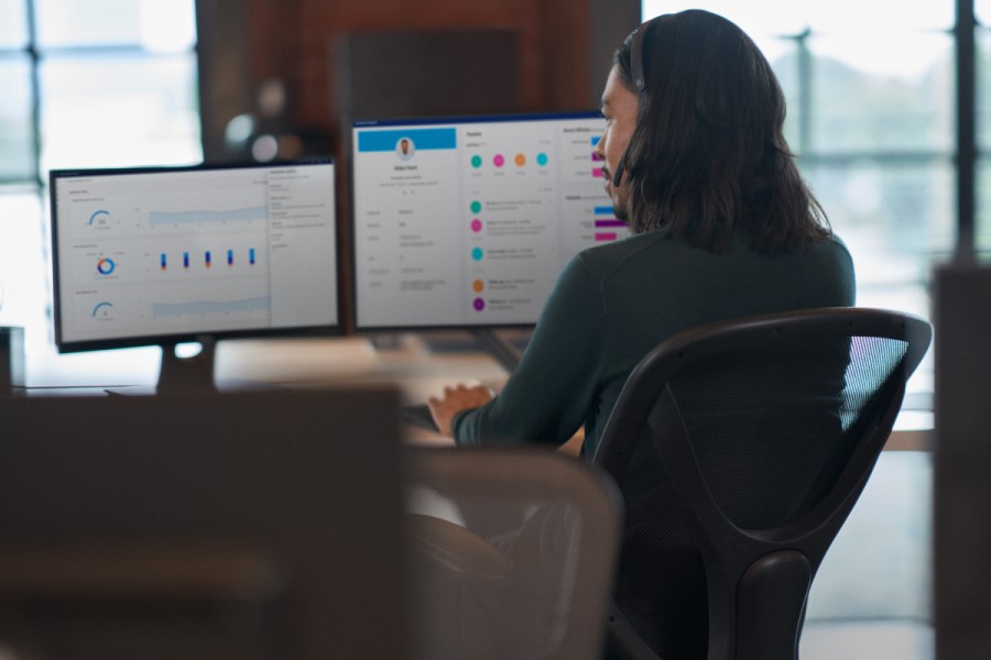 a person sitting at a desk in front of a computer