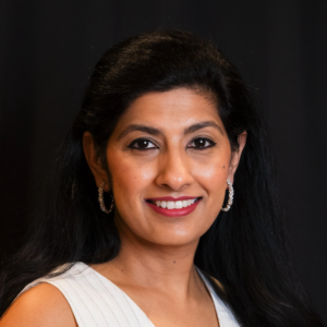 A woman with long black hair and a white dress