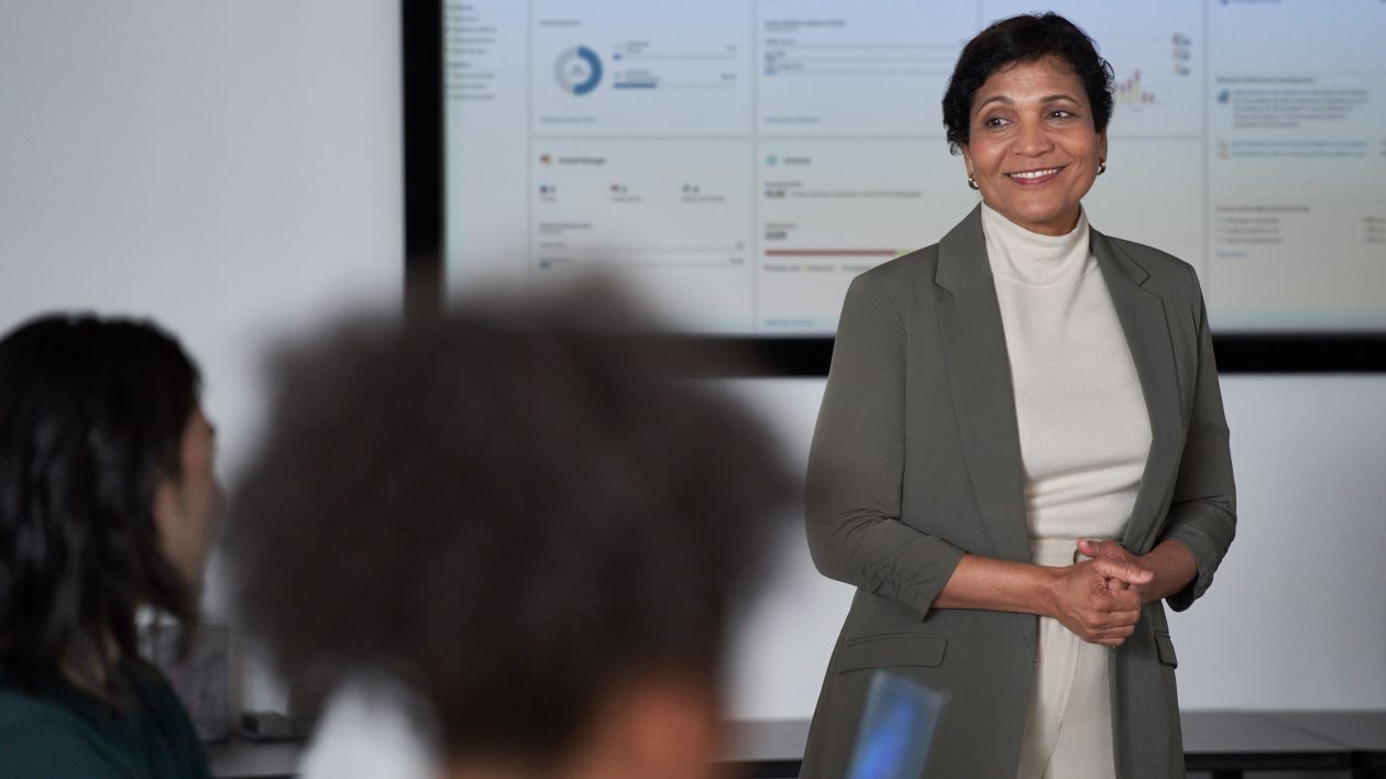 A woman presents information in a meeting.