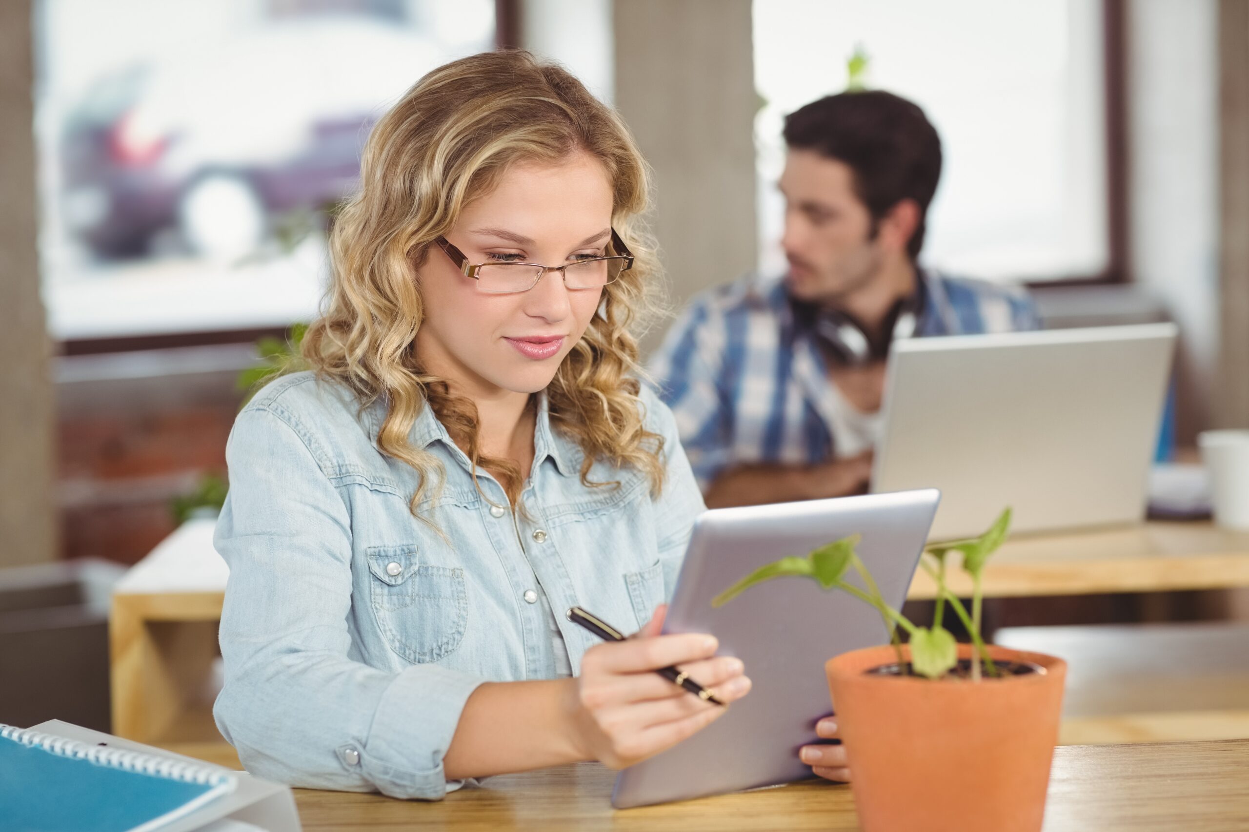 Young woman using digital tablet at creative office