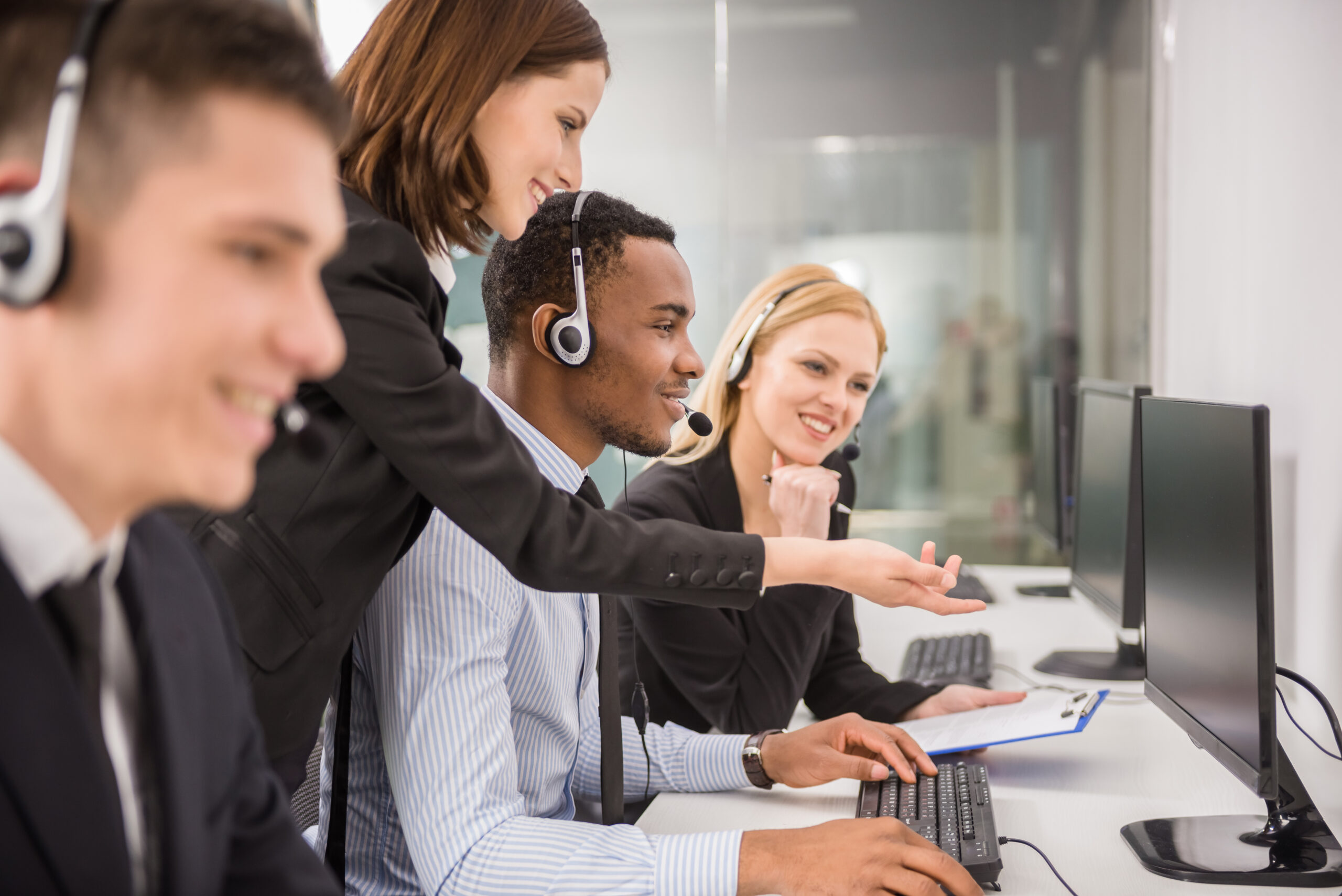 Side view of female manager assisting her staffs in a call center.