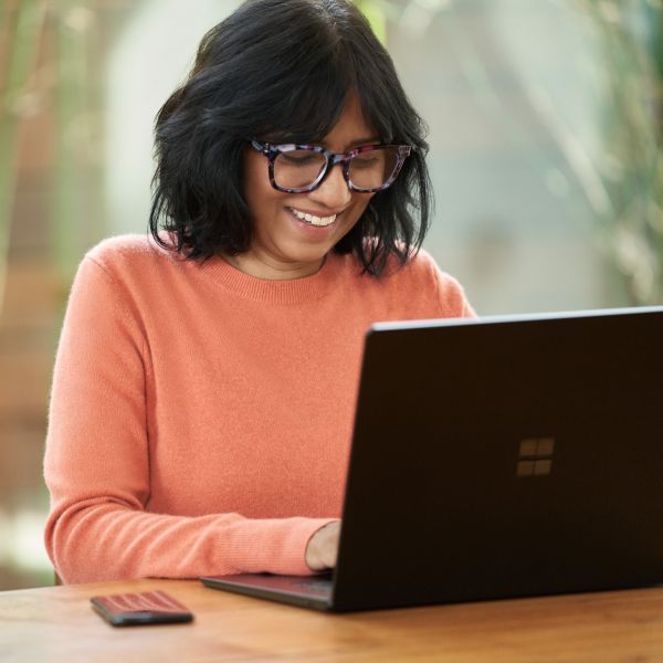 An education decision maker works on a laptop.