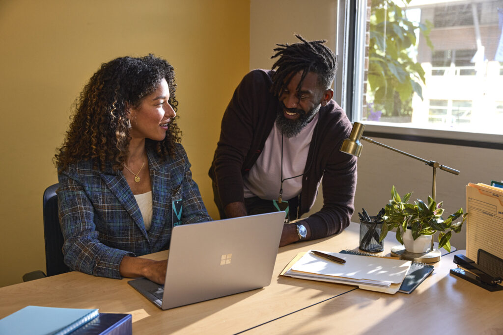 Two education leaders collaborating in an office at an educational institution.