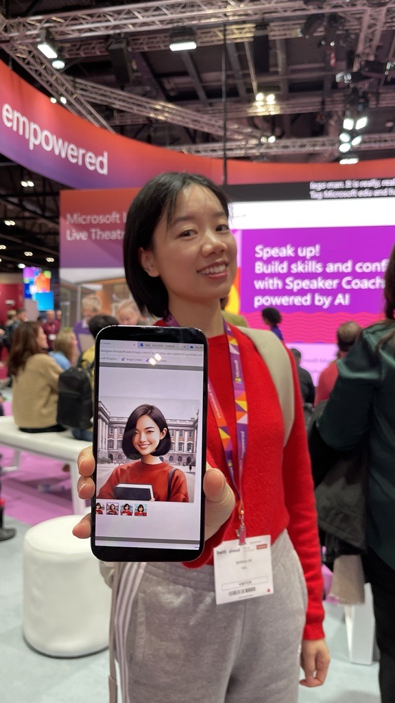 A conference attendee showing their phone which displays an AI-generated avatar of themself.  
