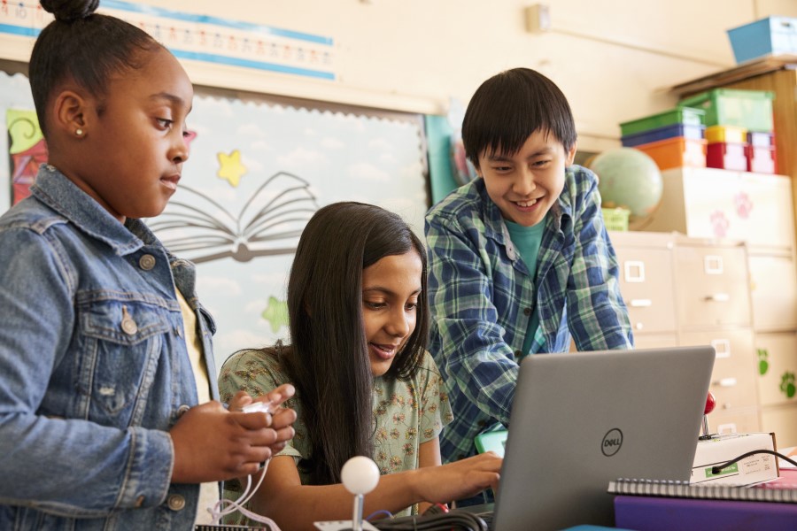 Decorative. Students working on a STEM project together at a table in a school classroom.
