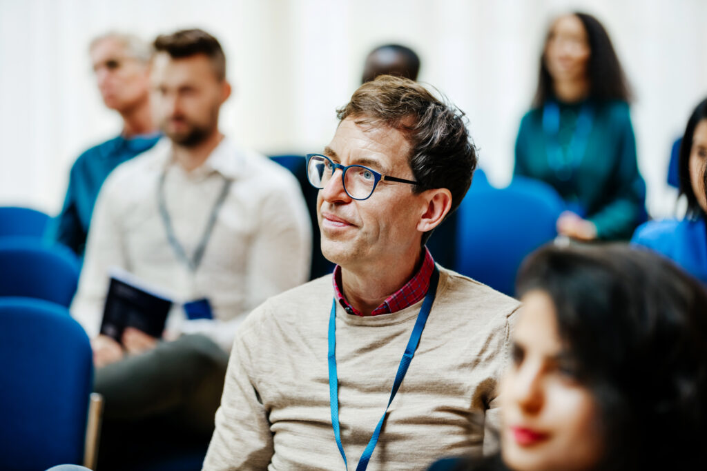 An attendee listening to a presentation at the 2026 Microsoft Digital Sovereignty Summit.