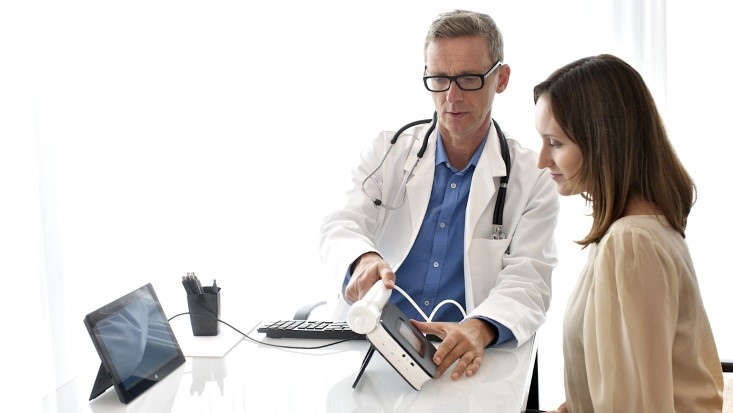 A doctor showing medical information to a patient