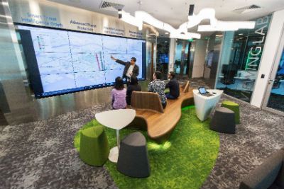 four-people-looking-at-analytics-large-touchscreen.2