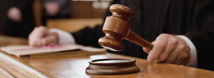 Judge holding gavel in courtroom