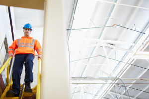A man on a work site with a hard hat.
