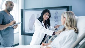Doctors talking with a patient.