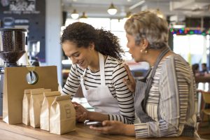 Two women working in a coffee shop.