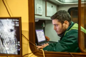 a man sitting at a table using a laptop computer
