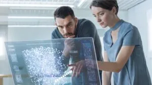 a woman and man looking at a digital computer screen