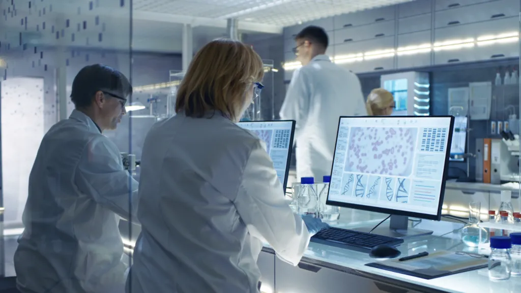 a group of people looking at a laptop