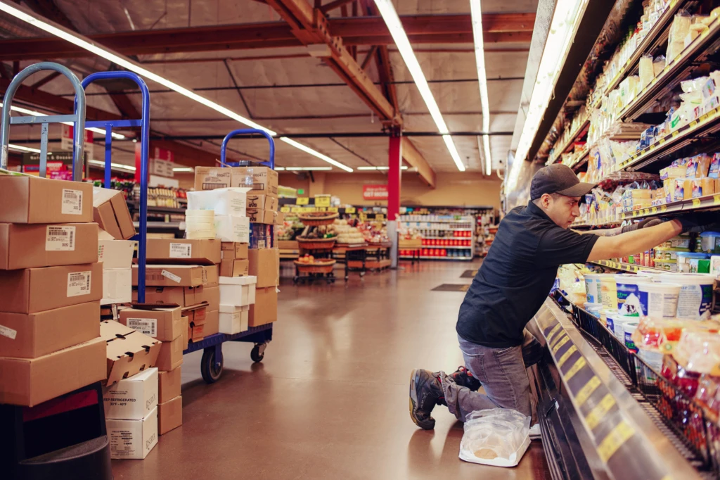 grocery store employee stocking shelves