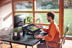 a person sitting at a desk in front of a window