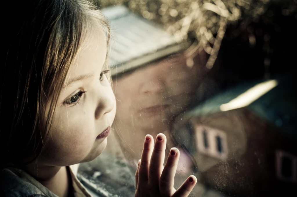 Little girl looking out the window