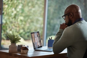 person sitting at a desk on a Teams video conference call