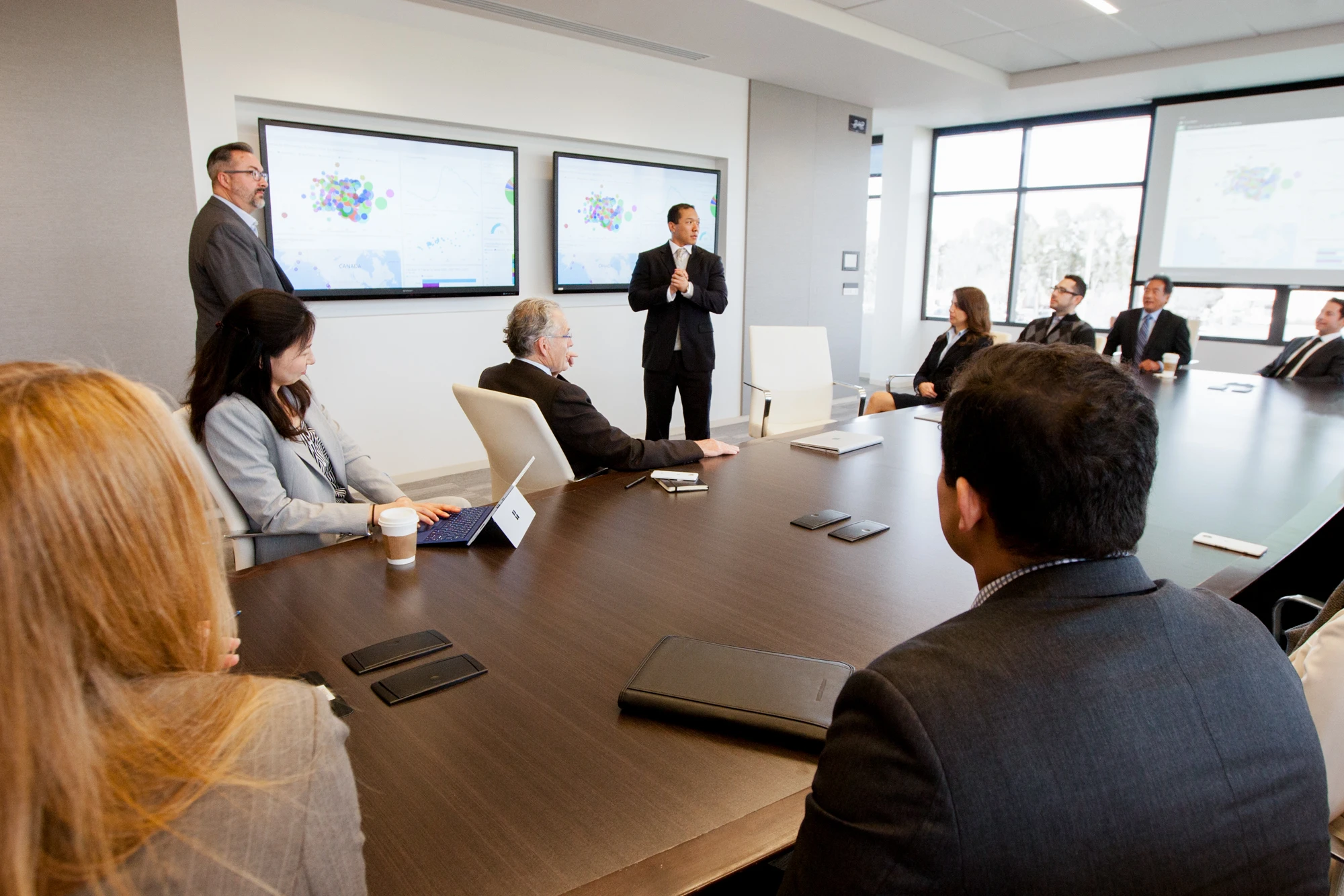 a group of people sitting at a table in front of a computer