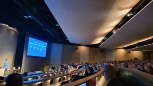 A group of people watching a presentation