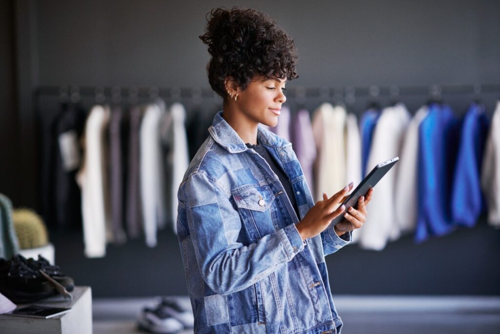 Azure solution in retail store. Empowered retails store manager in focus work viewing real-time data powered by Azure.