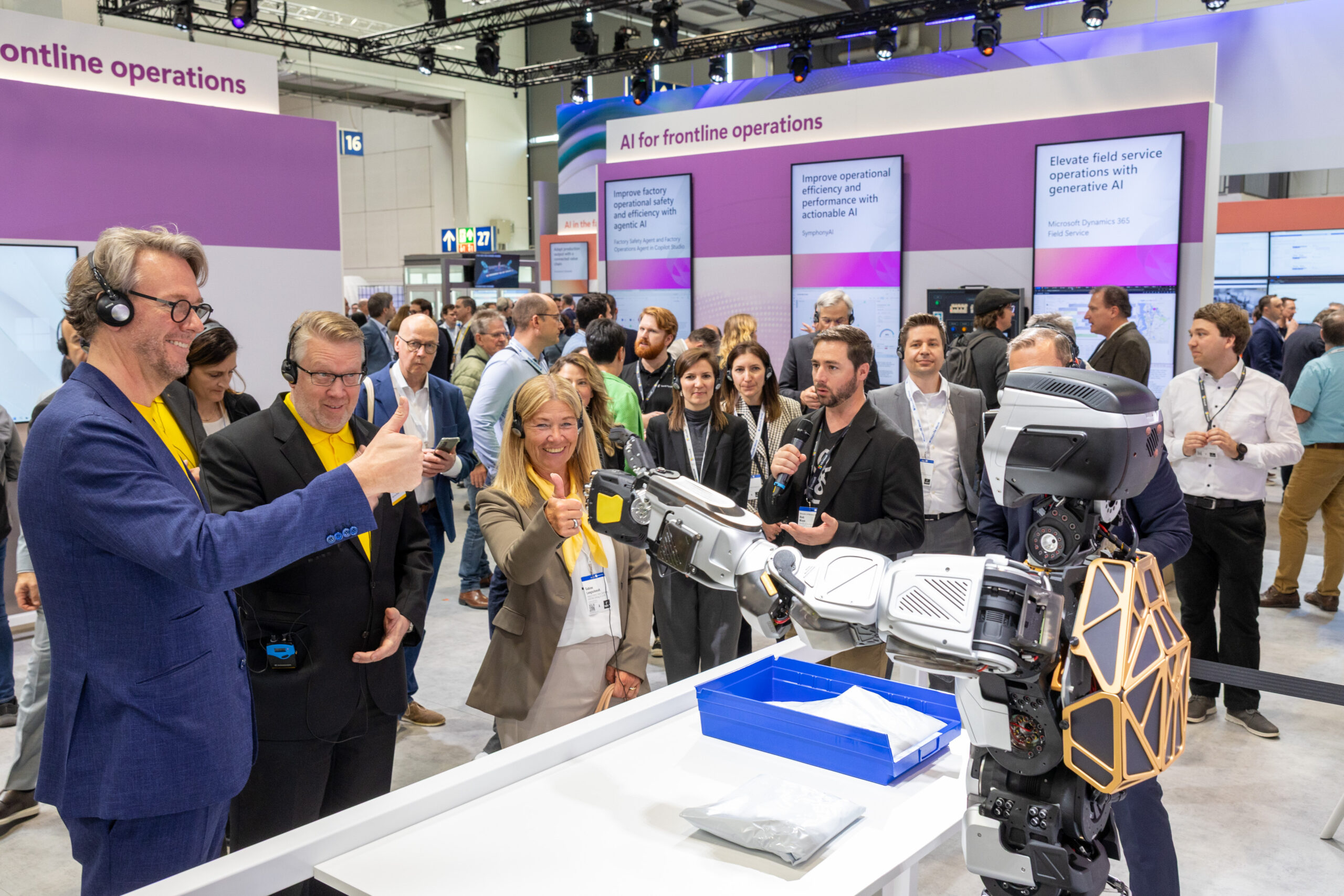 Hannover attendees interact with a Sanctuary AI humanoid in the Microsoft booth. 