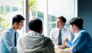 Group of professionals discussing strategic plans in a meeting room.