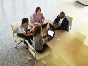 A Lenovo device being used by a mixed-gender team in an office space.