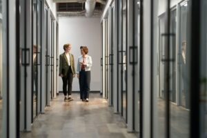 Two professionals collaborating in a modern, technology-enabled workplace.