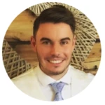 Chester, a smiling man wearing a suit and tie