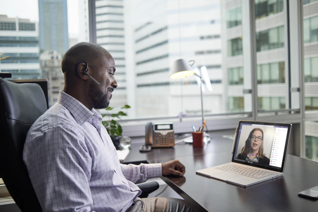 A man sitting in an office on a Teams video meeting. Collaboration tools are vital for the future of work.