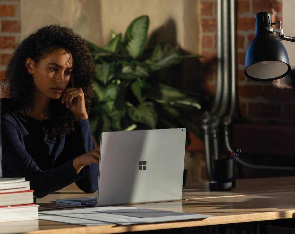 A woman working on a laptop at home. Hybrid working will be a key driver of innovation.