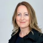 Heather Schossig, a woman smiling for the camera