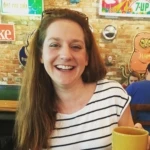 Liz Leigh-Bower smiling at the camera.