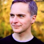 Terry Room smiling, focussing in the distance off-camera.