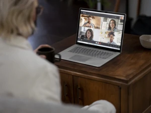 Adult male working from home viewing a Microsoft Teams call on Surface laptop 3