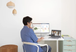 An employee experience empowers workers. A man works from home on a Teams call.