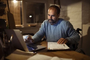 A man sitting at a table using a laptop at home in a data-driven culture