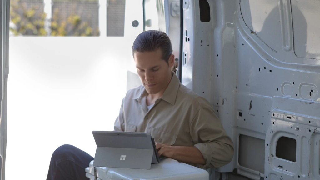 man working on his surface pro