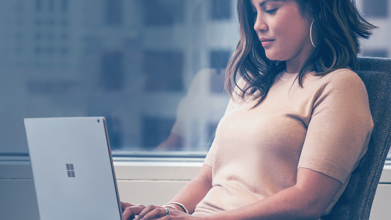 Woman working on a Surface device.