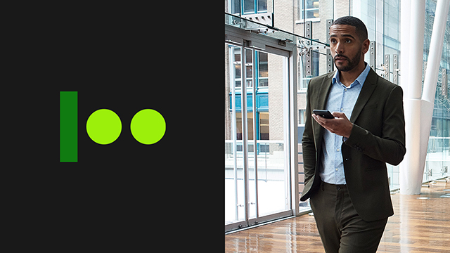 Man holding a phone looking up at something ahead.