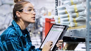 Woman checking things off her tablet
