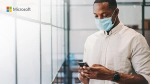 man with a face mask texting on his phone
