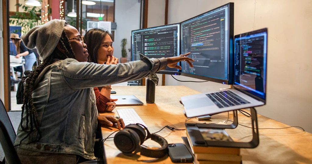 Developers working and collaborating in an enterprise office.
