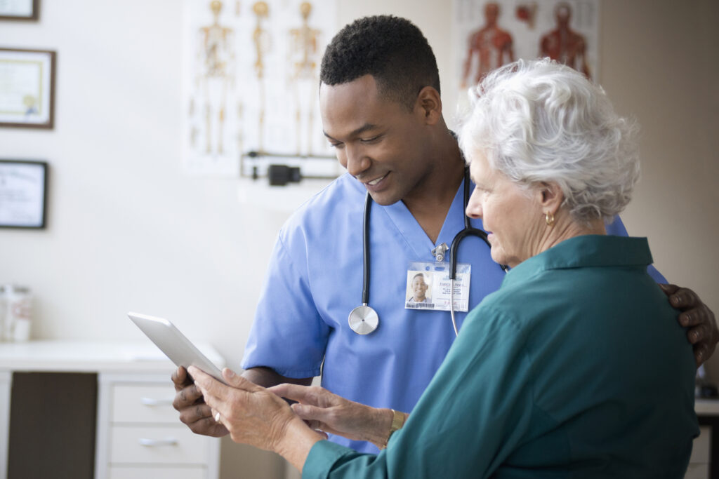 A doctor showing a tablet to a woman