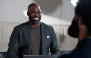 Two colleagues in an office environment with a laptop
