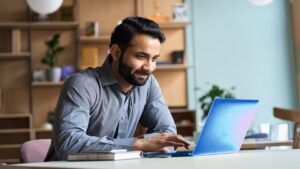 Business decision maker in an office setting working on a laptop with Microsoft scan technology