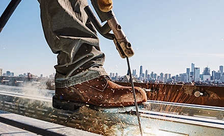 Image of a Red Wing shoe near welding sparks.