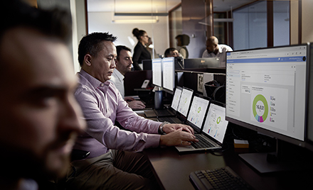 Image of tech workers working at a desk.